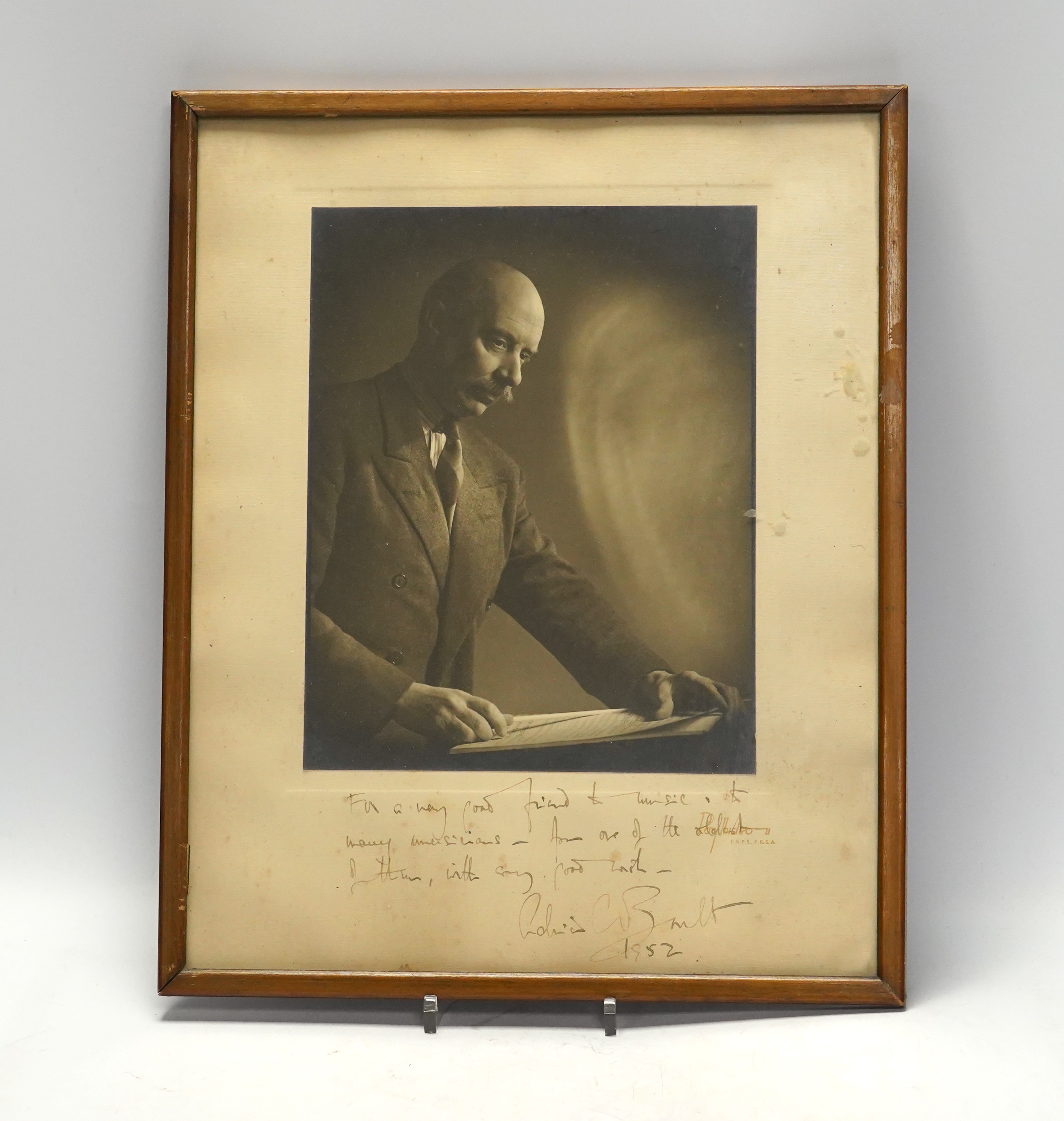 A signed photograph of the conductor Sir Adrian Boult with dedication dated 1952, frame 39.5 x 32cm